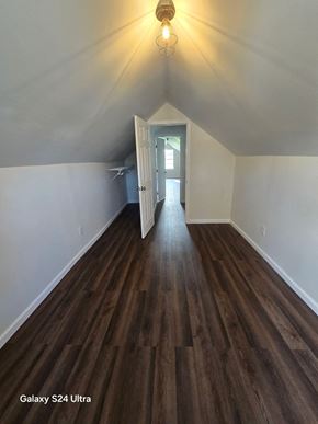 St. Louis house for rent - a room with hardwood flooring and white walls and a hallway with a door