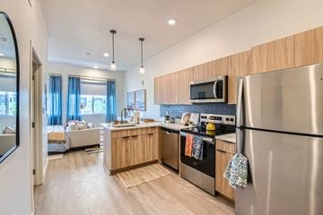 Salt Lake City apartment for rent - A modern kitchen with wooden cabinets and stainless steel appliances.