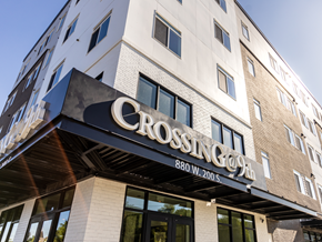 Salt Lake City apartment for rent - The front of a building with a sign that says "Crossing" on it.