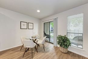 Austin apartment for rent - A dining room with a glass table and chairs.