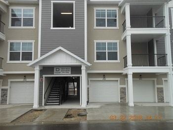 Lehi house for rent - an empty garage door in front of an apartment building