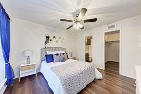 Austin apartment for rent - A bedroom with a bed, nightstand, and a ceiling fan.