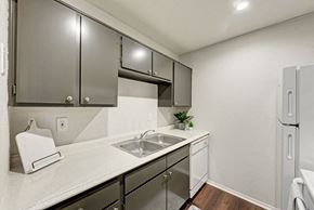 Austin apartment for rent - A kitchen with a white counter top and stainless steel appliances.