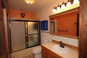 Whitefish apartment for rent - A bathroom with a toilet, sink, and shower.