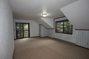 Whitefish apartment for rent - A room with carpeted floor and a window.