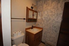 Whitefish apartment for rent - A bathroom with a toilet, sink and mirror.