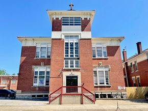 Louisville apartment for rent - A red brick building with a cross on top.