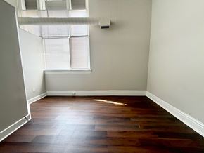 Louisville apartment for rent - A room with a window and wooden flooring.