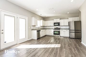 Smyrna house for rent - A modern kitchen with white cabinets and stainless steel appliances.