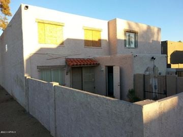 Phoenix apartment for rent - the front of a white house with a fence