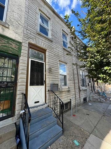 Philadelphia house for rent - the front of a building with stairs and a white door