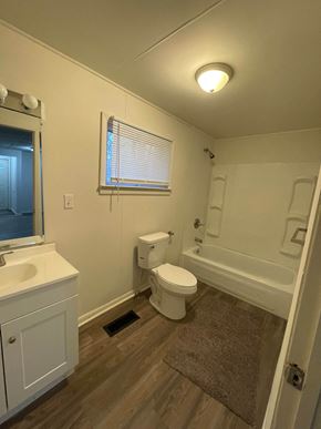Lima house for rent - A white bathroom with a toilet, sink, and bathtub.