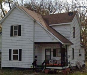 Lima house for rent - A small white house with a brown roof and a porch.