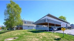 Anchorage apartment for rent - a car dealership with a car parked under a roof