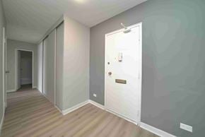 Winnipeg apartment for rent - A hallway with a white door and a wooden floor.