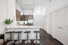 Richardson house for rent - a white kitchen with a bar and stools