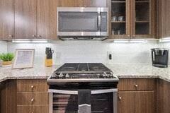 Richardson house for rent - a kitchen with a stove and a microwave