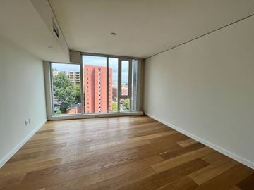 Seattle apartment for rent - Empty room with wooden flooring and sliding glass doors.