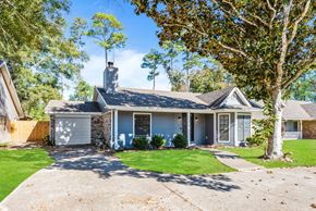 Slidell house for rent - A house with a grey roof and a white garage door.