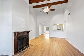 Slidell house for rent - A spacious room with a fireplace and a ceiling fan.