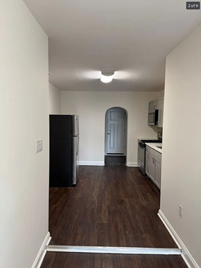 Baltimore house for rent - an empty kitchen with a refrigerator and a door