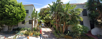 West Hollywood apartment for rent - A person walking a dog on a sidewalk.