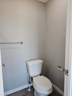 Guthrie house for rent - A white toilet in a small bathroom.