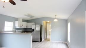 Slidell house for rent - A kitchen with a refrigerator, stove, and ceiling fan.