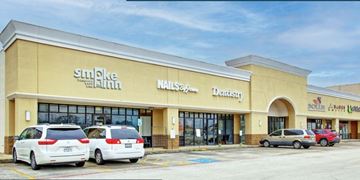 Spring apartment for rent - the front of a shopping mall with cars parked outside