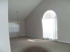 Slidell house for rent - A room with a chandelier and a large window.