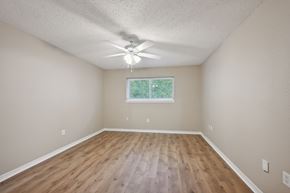 Slidell house for rent - A room with a ceiling fan and a window.
