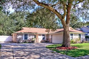 Slidell house for rent - A house with a tree in front of it.