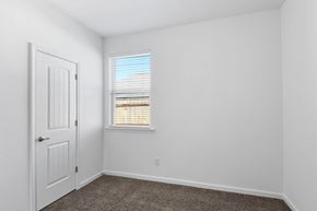 Slidell house for rent - A white door is on the left side of a room with a window on the right.
