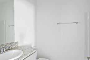 Slidell house for rent - A white bathroom with a sink and a towel rack.