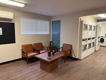 Spokane apartment for rent - an open living room and kitchen with a dining room table and a ceiling fan
