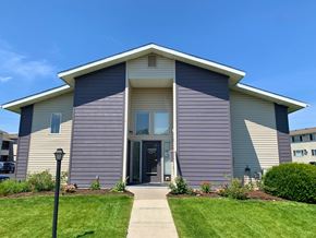 Spokane Valley apartment for rent - a sign for adams square apartments on a rock wall