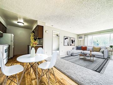 Spokane Valley apartment for rent - a living room with a couch and a table and chairs