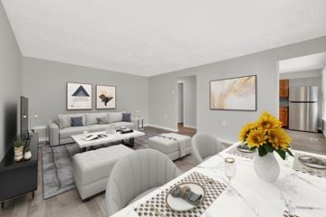Ogden apartment for rent - a living room with white furniture and a table with flowers