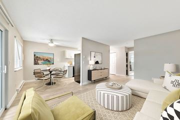 Portland apartment for rent - a living room with a couch and a table with chairs