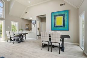 Dallas apartment for rent - a swimming pool with chairs in front of an apartment building