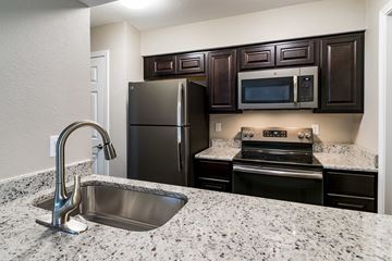 Denton apartment for rent - a kitchen with stainless steel appliances and granite counter tops