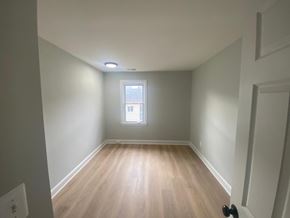 Washington apartment for rent - A room with a window and wooden flooring.