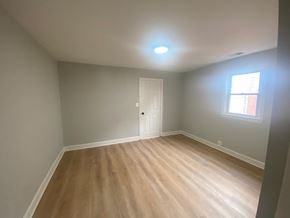 Washington apartment for rent - A room with a wooden floor and a white door.