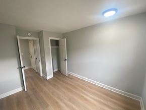 Washington apartment for rent - A room with wooden flooring and two open doors.