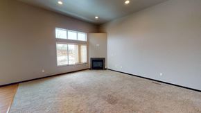 Fargo townhouse for rent - A spacious room with a flat screen TV and a window.