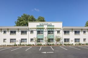 Tampa apartment for rent - A white building with a green awning and the words "Bayshore Plaza" on the front.