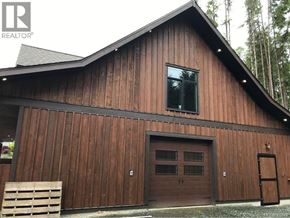 Sooke multi-family for rent - an aerial view of a neighborhood with trees and a body of water