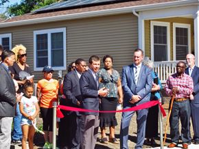 South Bend apartment for rent - A ribbon cutting ceremony outside a house.