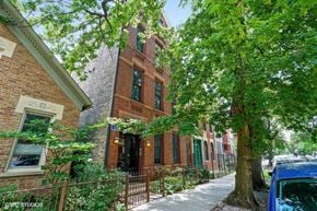 Chicago apartment for rent - a brick building with a tree in front of it