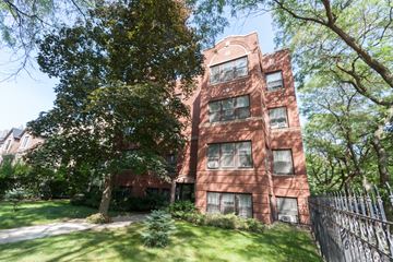 Chicago apartment for rent - an old brick building with grass and trees in front of it